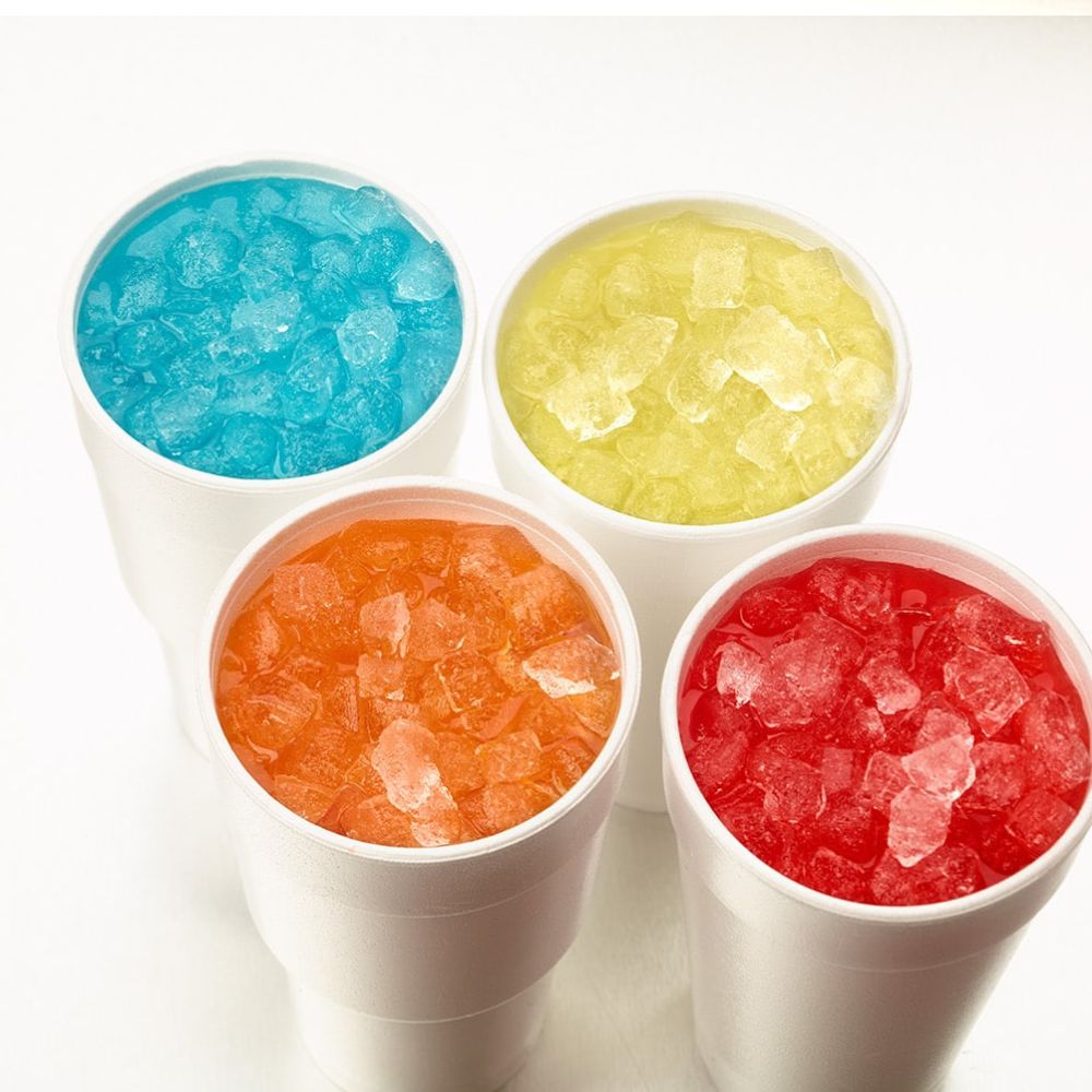 Four white cups with colorful crushed ice from the Hoshizaki DCM-271BAH Ice Maker and Water Dispenser