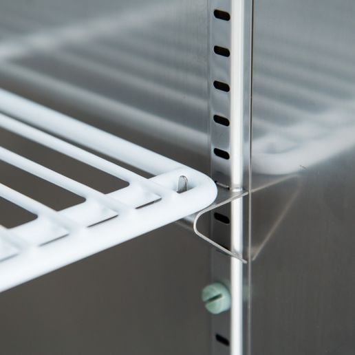 Adjustable shelf support inside a one door commercial freezer