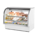 Curved glass deli case by True Refrigeration displaying assorted food items on shelves